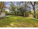 Spacious backyard with a lush lawn, mature trees, and a privacy fence, ideal for outdoor activities at 26 Standish Nw Ave, Atlanta, GA 30309