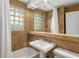 Well-lit bathroom with glass block window and a pedestal sink at 26 Standish Nw Ave, Atlanta, GA 30309