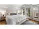 Bedroom with hardwood floors, white bedding, and natural light at 26 Standish Nw Ave, Atlanta, GA 30309