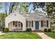 Charming home with a blue door, rocking chairs on the front porch, and a well-manicured lawn at 26 Standish Nw Ave, Atlanta, GA 30309