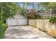 Two-car garage with a driveway, surrounded by lush greenery and mature trees at 26 Standish Nw Ave, Atlanta, GA 30309