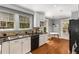 Modern kitchen with hardwood floors, white cabinets, and stainless steel appliances at 26 Standish Nw Ave, Atlanta, GA 30309