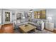 Spacious living room with a large sectional sofa, hardwood floors, and an open layout at 26 Standish Nw Ave, Atlanta, GA 30309