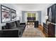 Home office with dark wood furniture, vintage posters, and a gray couch at 26 Standish Nw Ave, Atlanta, GA 30309