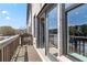 This inviting balcony features a wooden railing, brick accents, and serene outdoor views at 612 Marimba Pike, Mcdonough, GA 30253