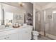 Modern bathroom featuring dual sinks, white cabinets, and a glass-enclosed shower at 612 Marimba Pike, Mcdonough, GA 30253