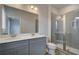 Bathroom featuring double sinks, gray cabinetry, and a tiled glass shower at 612 Marimba Pike, Mcdonough, GA 30253