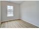 Empty bedroom with light wood floors and natural light from a large window at 612 Marimba Pike, Mcdonough, GA 30253