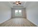 Spacious bedroom featuring tray ceilings, wood flooring, and double windows offering abundant natural light at 612 Marimba Pike, Mcdonough, GA 30253