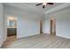 Bright bedroom with wood floors leading to the bathroom and closets at 612 Marimba Pike, Mcdonough, GA 30253