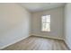 Cozy bedroom with hardwood floors, a window, and neutral paint at 612 Marimba Pike, Mcdonough, GA 30253
