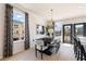 Bright dining room features a modern chandelier and black and white decor, providing an elegant space for meals at 612 Marimba Pike, Mcdonough, GA 30253