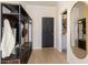 Entryway with coat rack, decorative mirror, and a door leading to a bathroom at 612 Marimba Pike, Mcdonough, GA 30253