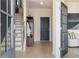 Inviting entryway featuring light wood floors, a coat rack, and a staircase leading to the upper levels at 612 Marimba Pike, Mcdonough, GA 30253