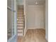 Inviting entryway with hardwood floors, stairs to upper level, and neutral paint at 612 Marimba Pike, Mcdonough, GA 30253
