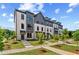 Beautiful townhomes with brick facade, gray accents, landscaped yard, and inviting entryway at 612 Marimba Pike, Mcdonough, GA 30253