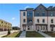 Modern townhomes feature brick facade and manicured lawn at 612 Marimba Pike, Mcdonough, GA 30253