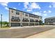 Modern townhome exterior featuring private balconies and attached garages under a cloudy blue sky at 612 Marimba Pike, Mcdonough, GA 30253