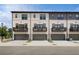 Modern townhome exteriors with gray trim, balconies, and two-car garages at 612 Marimba Pike, Mcdonough, GA 30253