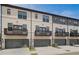 Elegant townhomes featuring gray accents, balconies, and two-car garages for convenient parking at 612 Marimba Pike, Mcdonough, GA 30253