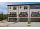 Charming townhomes with light brick, gray trim, balconies, and two-car garages at 612 Marimba Pike, Mcdonough, GA 30253