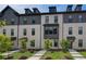 Beautiful townhomes with light brick and dark accents in a well-maintained community at 612 Marimba Pike, Mcdonough, GA 30253