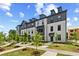 Attractive townhomes with lush green lawns, well-manicured gardens, and charming brick sidewalks at 612 Marimba Pike, Mcdonough, GA 30253