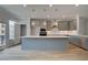 Modern kitchen with a large island, stainless steel appliances, and pendant lighting at 612 Marimba Pike, Mcdonough, GA 30253