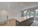 Kitchen island featuring gray cabinets, light countertops, pendant lighting, and access to outdoor patio at 612 Marimba Pike, Mcdonough, GA 30253