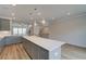 Open-concept kitchen with gray cabinets, quartz countertops, and a large island with pendant lighting at 612 Marimba Pike, Mcdonough, GA 30253