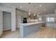 Contemporary kitchen featuring a large island, stainless steel appliances, and hardwood floors at 612 Marimba Pike, Mcdonough, GA 30253