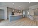 Open-concept kitchen with a large island, stainless steel appliances, and modern lighting at 612 Marimba Pike, Mcdonough, GA 30253