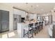 This open-concept kitchen features a large island with pendant lighting and stainless steel appliances for a modern design at 612 Marimba Pike, Mcdonough, GA 30253