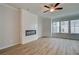 Bright living room featuring a modern fireplace, light wood floors, and lots of natural light at 612 Marimba Pike, Mcdonough, GA 30253