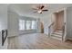 Spacious living room with a modern fireplace, staircase, and bright windows at 612 Marimba Pike, Mcdonough, GA 30253