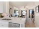 The stylish living room features a modern fireplace, sleek TV, and connects to a bright, open kitchen area at 612 Marimba Pike, Mcdonough, GA 30253