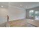 Inviting living room area with hardwood floors, and natural light from a large window at 612 Marimba Pike, Mcdonough, GA 30253