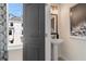Cozy powder room boasts a pedestal sink, decorative mirror, and natural light from the window at 612 Marimba Pike, Mcdonough, GA 30253