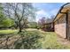 Lush backyard with mature trees, a screened porch, and a well-manicured lawn, ideal for outdoor gatherings and relaxation at 6348 Garnet Dr, Douglasville, GA 30135