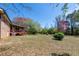 Scenic backyard with a spacious lawn, mature trees and a screened porch offering a serene outdoor retreat at 6348 Garnet Dr, Douglasville, GA 30135