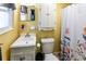 Bathroom with yellow walls featuring a floral shower curtain and sink at 6348 Garnet Dr, Douglasville, GA 30135