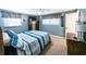 A cozy bedroom with blue walls, carpet, and a queen-sized bed at 6348 Garnet Dr, Douglasville, GA 30135