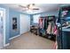 Bedroom with light blue walls, two windows, ceiling fan, closet racks and shelves at 6348 Garnet Dr, Douglasville, GA 30135