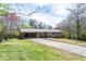 A single-story brick home boasting a carport, spacious front yard, and long driveway at 6348 Garnet Dr, Douglasville, GA 30135