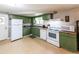 Functional kitchen with ample counter space, green cabinets, and modern appliances at 6348 Garnet Dr, Douglasville, GA 30135