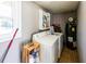 View of a laundry room with a washer, dryer, shelving and water heater at 6348 Garnet Dr, Douglasville, GA 30135