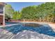 Covered pool with a surrounding patio and privacy landscaping provides a tranquil backyard retreat at 5265 Cole Creek Ln, Cumming, GA 30040