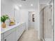 Modern bathroom with double sinks, white cabinets, tile flooring, and a glass-enclosed shower at 1395 Windance Lake Dr, Loganville, GA 30052