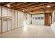 Unfinished basement features smooth concrete floor and walls, exposed ceiling and potential garage door at 3306 Sleepy Se Ln, Smyrna, GA 30080