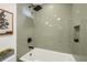 Modern bathroom featuring a sleek tub and shower with stylish tiling at 3306 Sleepy Se Ln, Smyrna, GA 30080